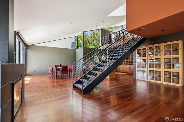 6353 Skyline Blvd, Oakland, CA 94611 - stairway with wood finished floors, a lit fireplace, recessed lighting, and a high ceiling