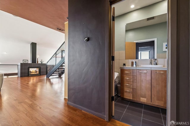 6353 Skyline Blvd, Oakland, CA 94611 - bathroom featuring vanity, toilet, wood finished floors, and a tiled fireplace