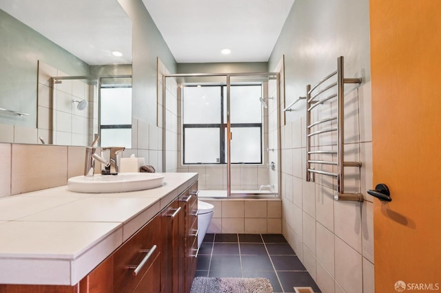 6353 Skyline Blvd, Oakland, CA 94611 - full bathroom with toilet, a towel warming rack, tile patterned flooring, vanity, and tile walls