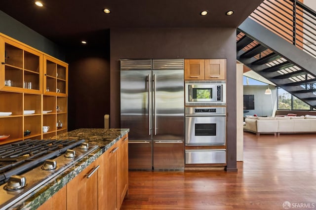 6353 Skyline Blvd, Oakland, CA 94611 - kitchen featuring built in appliances, a warming drawer, dark wood-style floors, dark stone counters, and recessed lighting