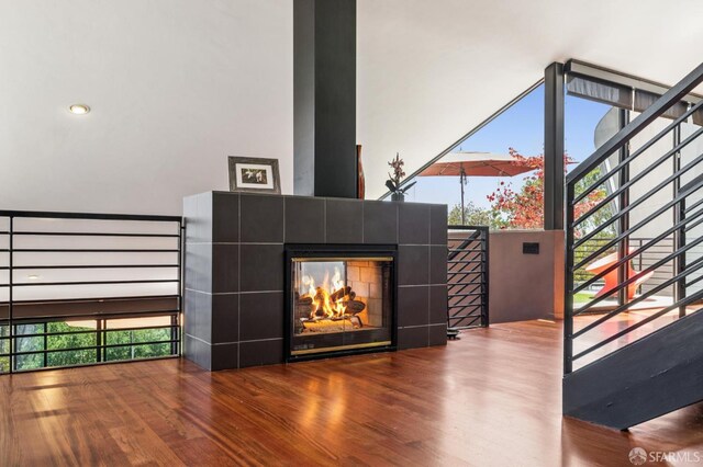 6353 Skyline Blvd, Oakland, CA 94611 - unfurnished living room with wood finished floors, a tile fireplace, and healthy amount of natural light