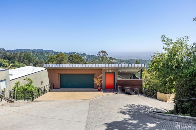 6353 Skyline Blvd, Oakland, CA 94611 - view of front of home with concrete driveway, stucco siding, and an attached garage