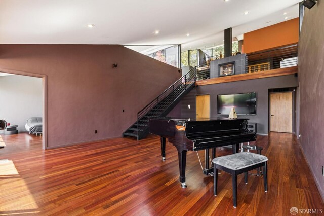 6353 Skyline Blvd, Oakland, CA 94611 - living area featuring stairway, wood finished floors, a high ceiling, recessed lighting, and baseboards