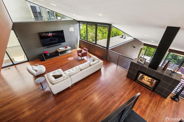 6353 Skyline Blvd, Oakland, CA 94611 - living room with a tile fireplace, wood finished floors, lofted ceiling, and recessed lighting