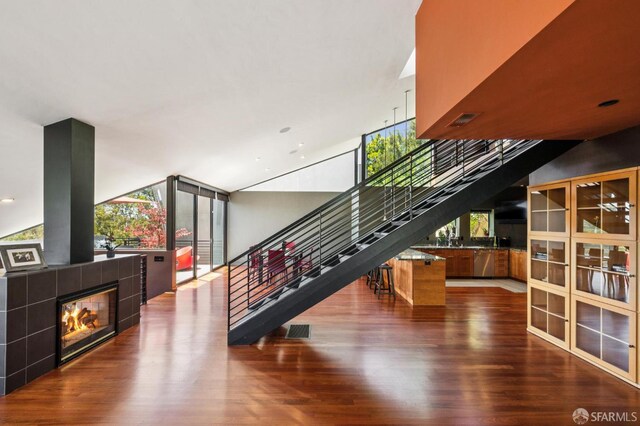 6353 Skyline Blvd, Oakland, CA 94611 - stairs featuring wood finished floors, a tiled fireplace, plenty of natural light, and recessed lighting