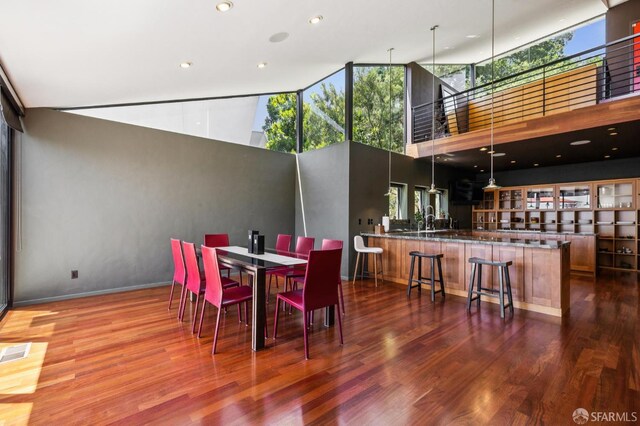 6353 Skyline Blvd, Oakland, CA 94611 - dining room featuring a towering ceiling, wood finished floors, recessed lighting, and baseboards