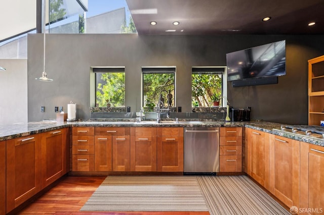 6353 Skyline Blvd, Oakland, CA 94611 - kitchen featuring appliances with stainless steel finishes, dark stone counters, a sink, wood finished floors, and brown cabinets