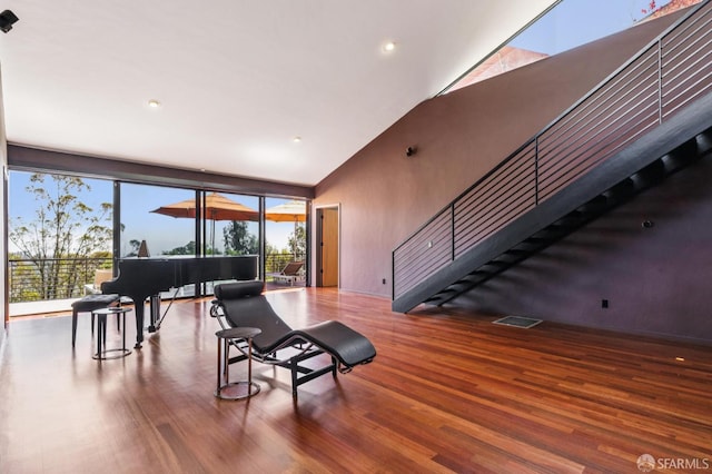 6353 Skyline Blvd, Oakland, CA 94611 - living room featuring wood finished floors, high vaulted ceiling, plenty of natural light, stairs, and recessed lighting