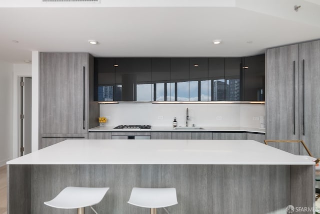 201 Folsom St Unit 38E, San Francisco, CA 94105 - kitchen featuring a sink, modern cabinets, gas cooktop, light countertops, and oven
