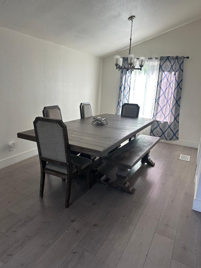 6517 Filaree Way, Sacramento, CA 95842 - dining room with a chandelier, wood-type flooring, baseboards, a textured ceiling, and a textured wall