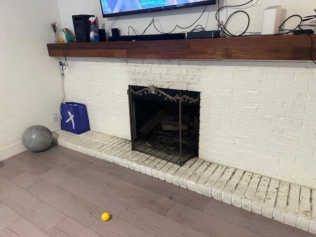 6517 Filaree Way, Sacramento, CA 95842 - detailed view of wood finished floors, baseboards, and a brick fireplace