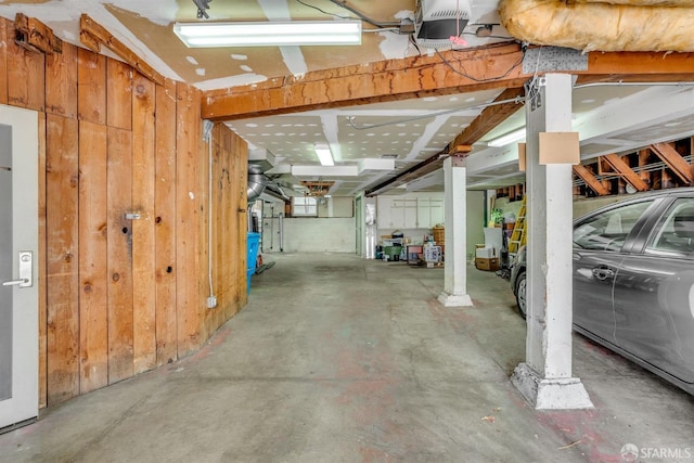 basement featuring wood walls