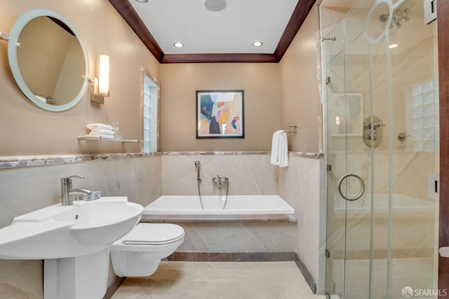 full bathroom featuring independent shower and bath, sink, tile walls, ornamental molding, and toilet