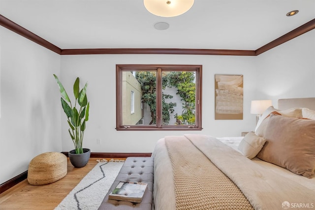 bedroom featuring hardwood / wood-style flooring and ornamental molding