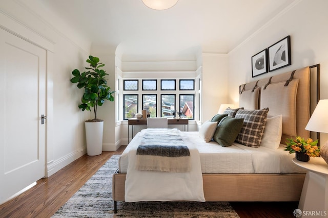 bedroom featuring hardwood / wood-style flooring and crown molding