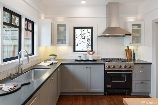 kitchen featuring sink, gray cabinets, premium range, and wall chimney range hood