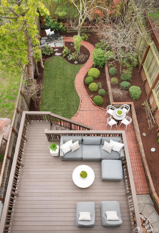 wooden terrace with an outdoor hangout area and a patio