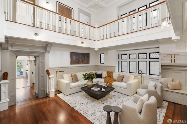 living room with dark hardwood / wood-style floors and a high ceiling