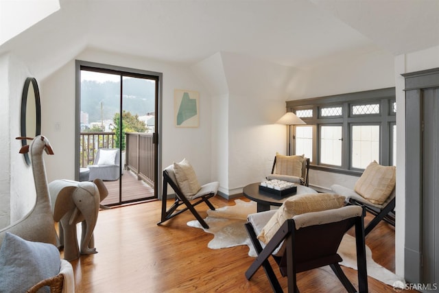 sitting room with light hardwood / wood-style floors and lofted ceiling