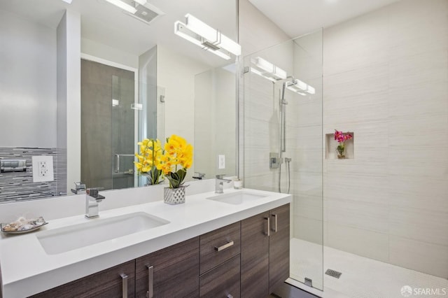 bathroom featuring vanity and a shower with shower door