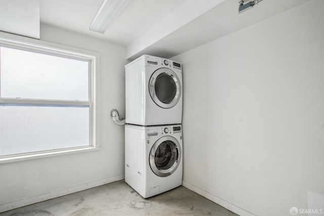 clothes washing area featuring stacked washer and clothes dryer