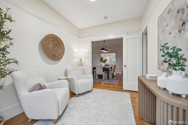 sitting room with hardwood / wood-style flooring