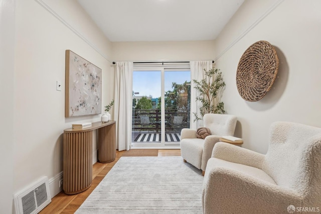 sitting room with hardwood / wood-style flooring