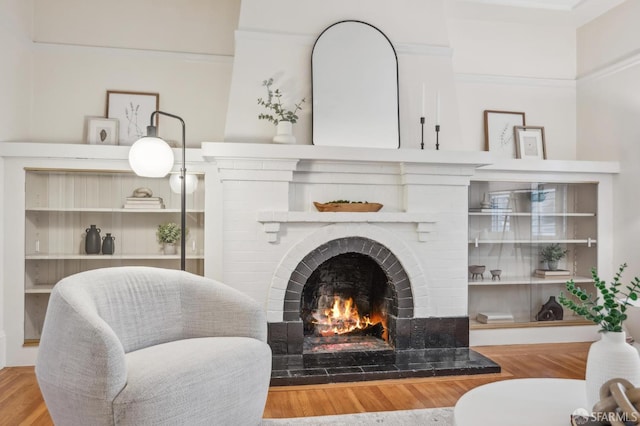 living area featuring hardwood / wood-style flooring and a fireplace