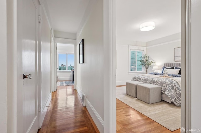 hallway with hardwood / wood-style flooring