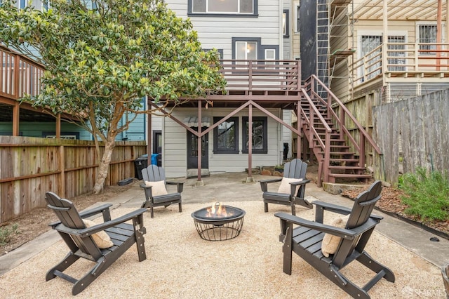 view of patio with a wooden deck and a fire pit