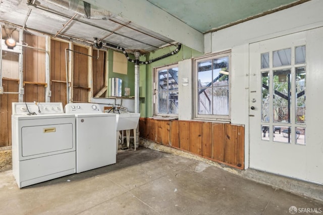 laundry area with separate washer and dryer and sink