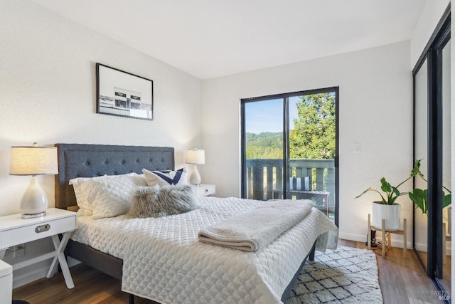 bedroom featuring hardwood / wood-style floors and access to outside