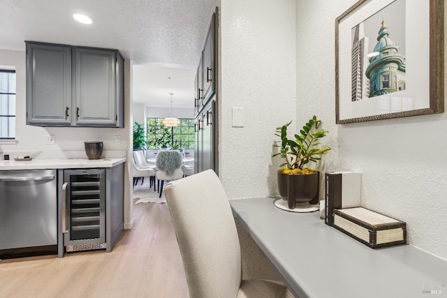 bar with stainless steel dishwasher, plenty of natural light, beverage cooler, and light hardwood / wood-style flooring