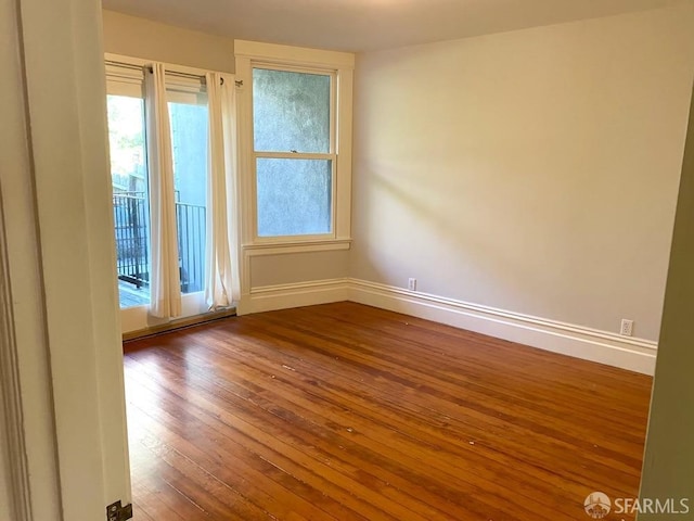 spare room featuring hardwood / wood-style floors