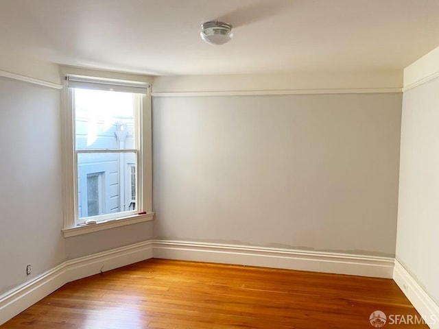 empty room with hardwood / wood-style floors