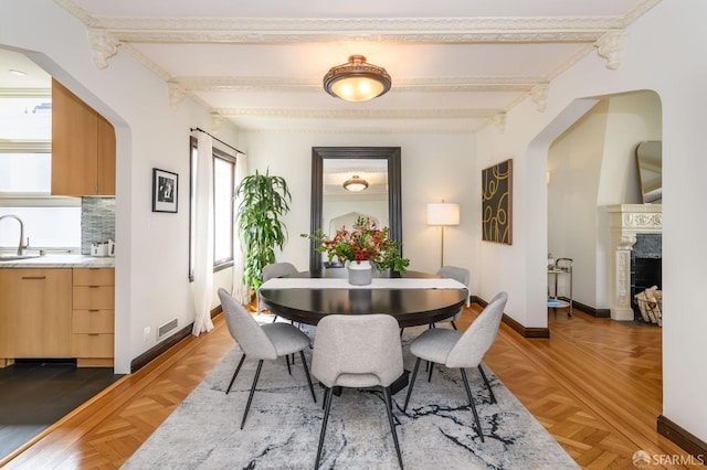 3544 Webster St, San Francisco, CA 94123 - dining space featuring beam ceiling, arched walkways, and a fireplace