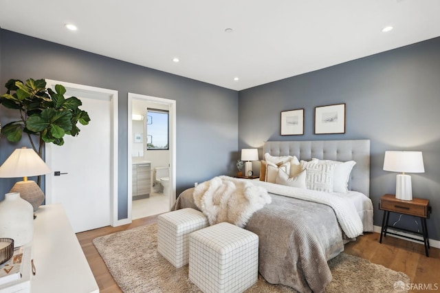 bedroom featuring wood-type flooring and connected bathroom