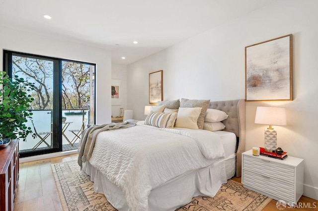 bedroom featuring light hardwood / wood-style floors and access to outside