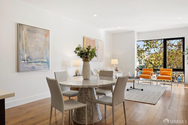 dining area with hardwood / wood-style flooring