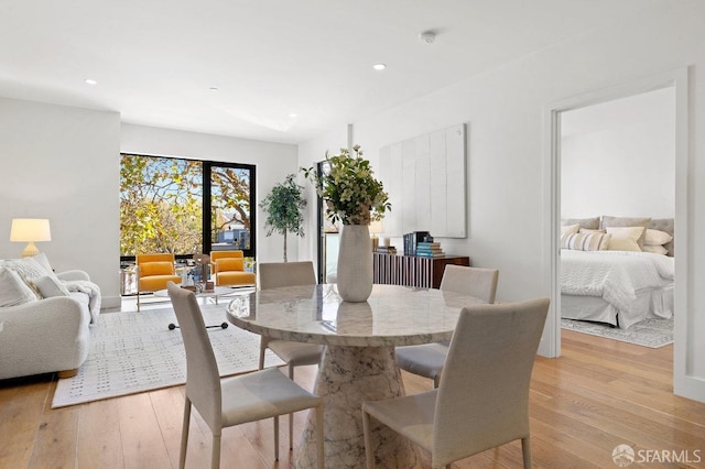 dining space with light hardwood / wood-style flooring