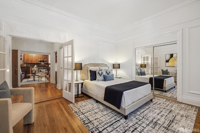 735 Geary St Unit 102, San Francisco, CA 94109 - bedroom featuring french doors, wood finished floors, ornamental molding, and a closet