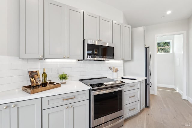 745 Redwood Rd, San Anselmo, CA 94960 - kitchen featuring stainless steel appliances, light countertops, baseboards, decorative backsplash, and recessed lighting