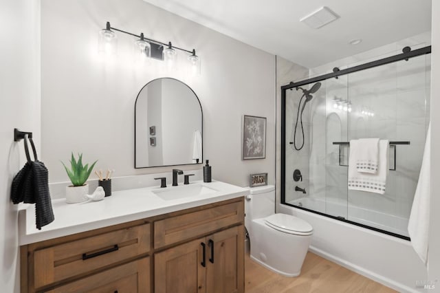 745 Redwood Rd, San Anselmo, CA 94960 - bathroom featuring toilet, vanity, bath / shower combo with glass door, and wood finished floors