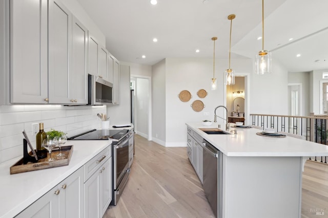 745 Redwood Rd, San Anselmo, CA 94960 - kitchen featuring a sink, stainless steel appliances, tasteful backsplash, light countertops, and light wood finished floors