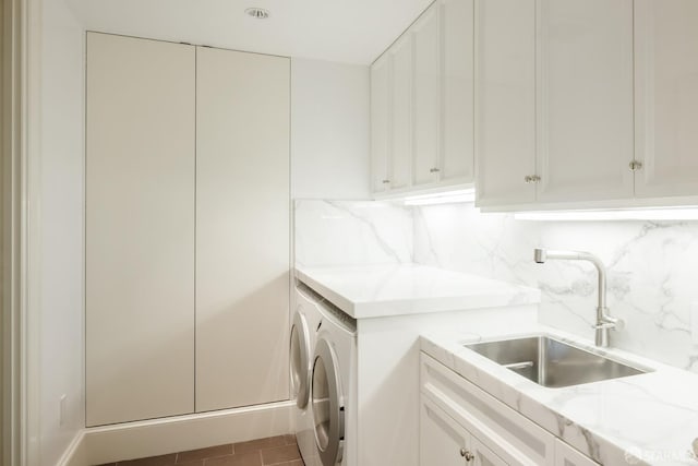 laundry room with cabinets, sink, and washing machine and clothes dryer