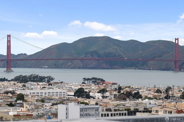 view of mountain feature featuring a view of city and a water view