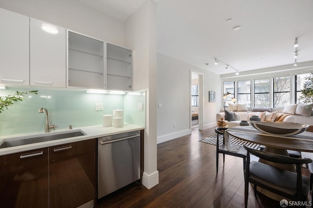 kitchen featuring dark wood finished floors, light countertops, a sink, modern cabinets, and dishwasher