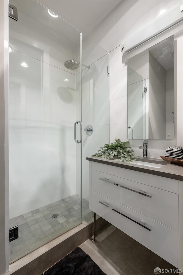 full bathroom with a stall shower and vanity