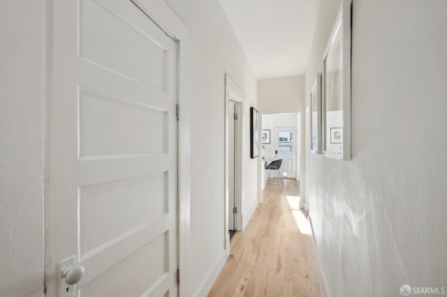 hall with light hardwood / wood-style flooring