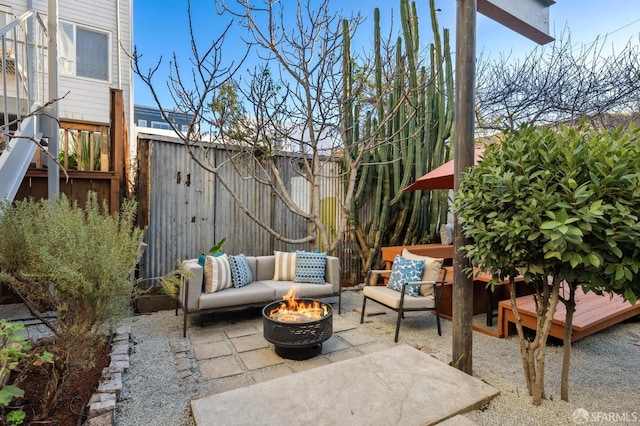 view of patio featuring an outdoor living space with a fire pit and a deck